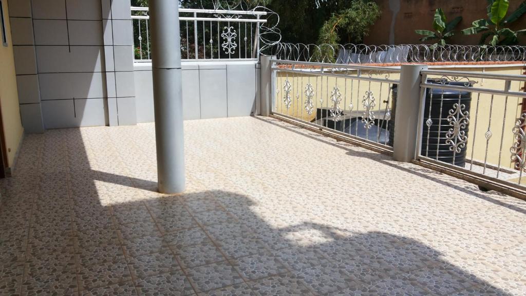 a balcony with a pole in front of a building at Hotel Dot Com Entebbe in Entebbe