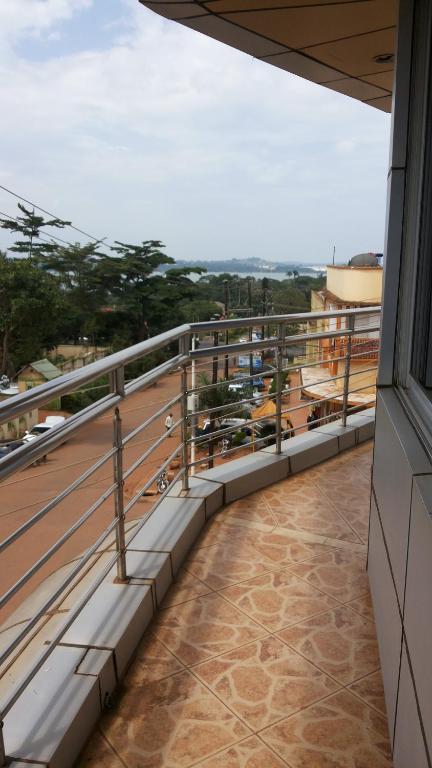 a balcony with a view of a city at Hotel Dot Com Entebbe in Entebbe