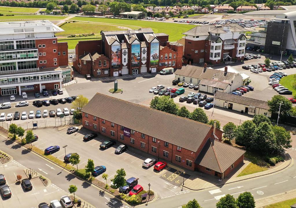 an aerial view of a town with a parking lot at Stables Inn, Aintree in Liverpool