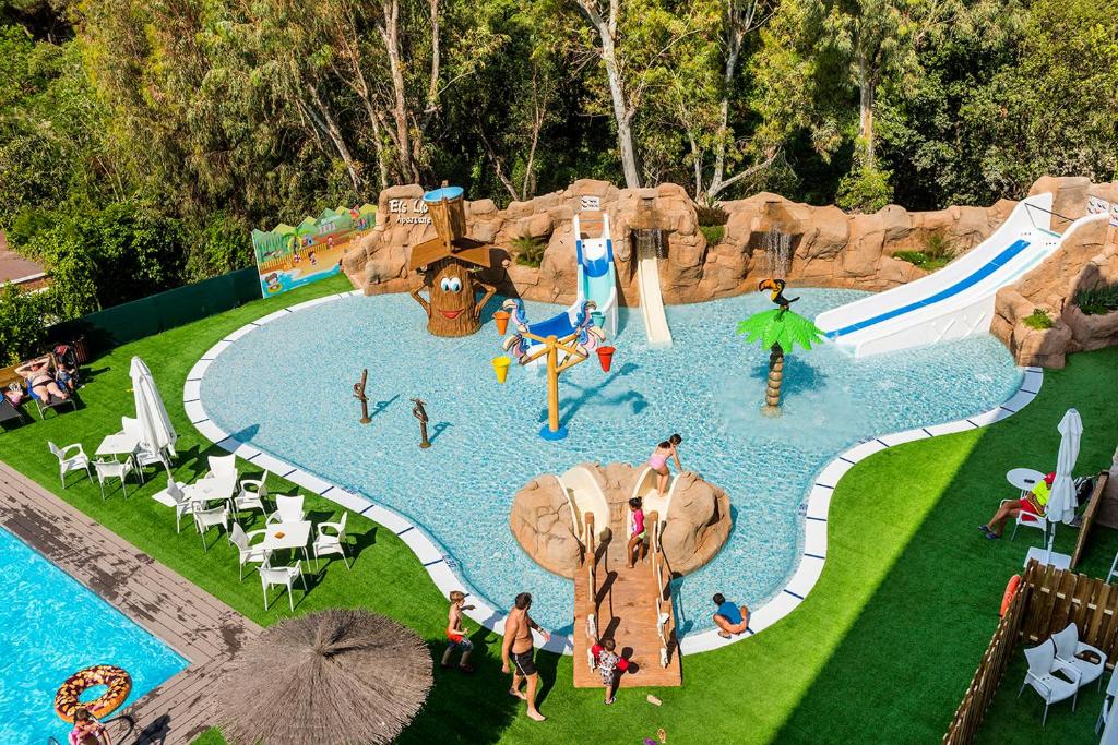 a group of people in a pool at a water park at Apartaments Els Llorers in Lloret de Mar