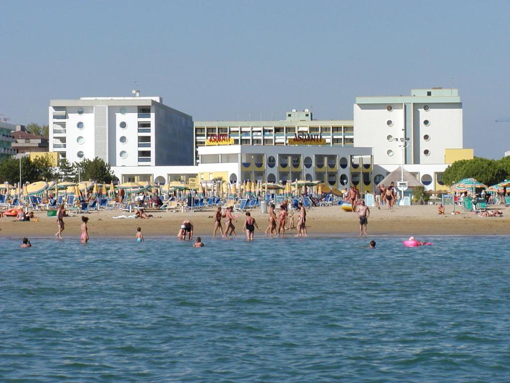 a group of people in the water at a beach at FLATS SOLARIUM in Bibione