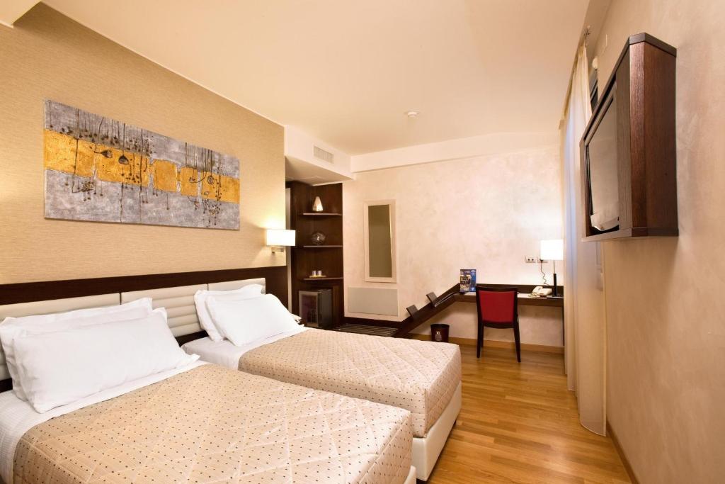 Postel nebo postele na pokoji v ubytování Breaking Business Hotel