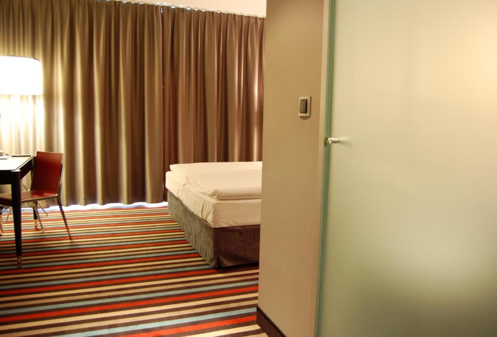 Postel nebo postele na pokoji v ubytování Silver Hotel & Gokart Center