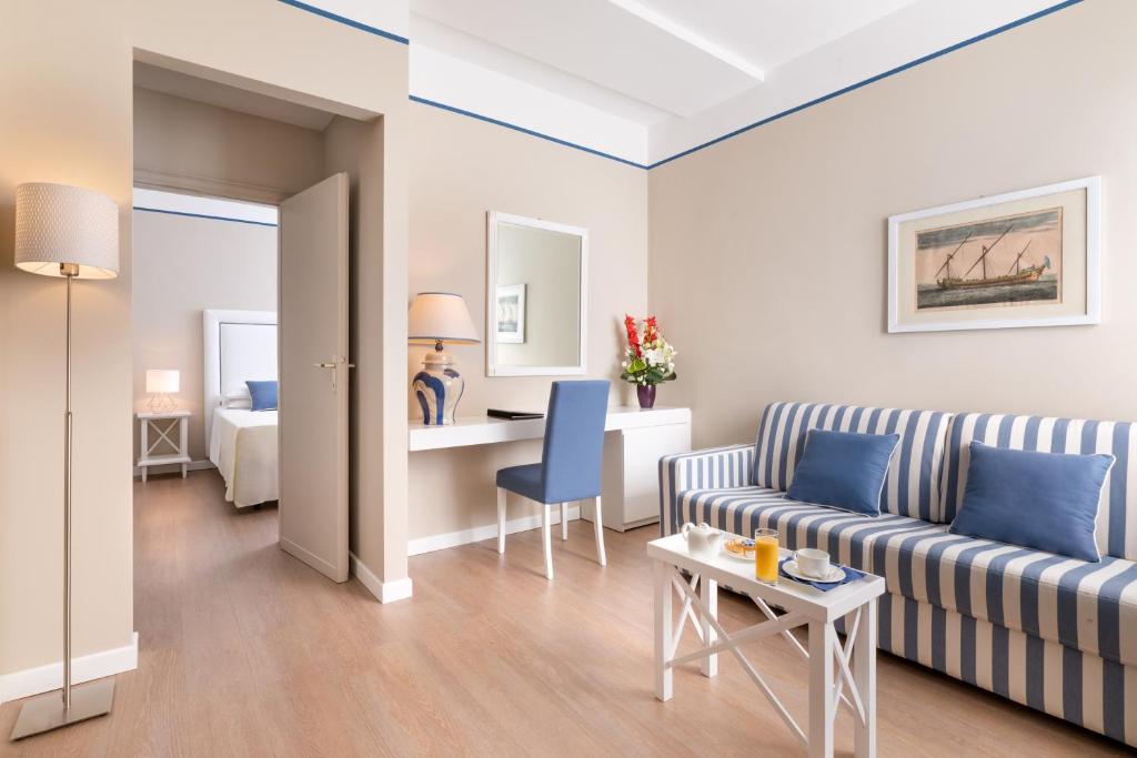 a living room with a couch and a table at Hotel Sina Astor in Viareggio