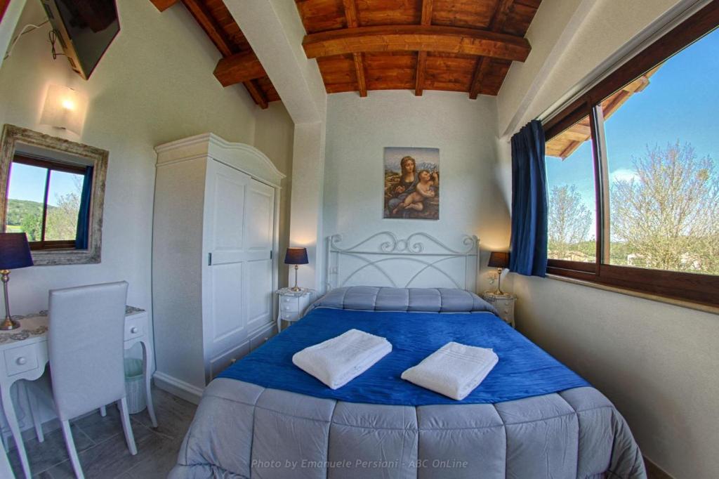 Postel nebo postele na pokoji v ubytování Agriturismo Baldassari