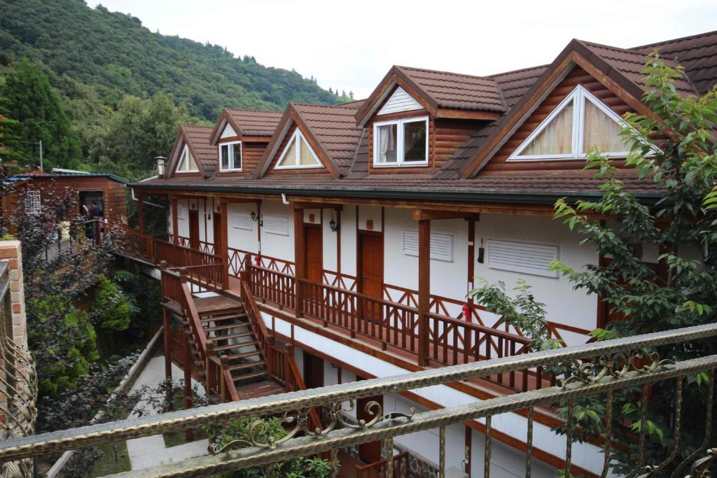 a house with wooden balconies and a mountain at Cingjing Vienna Pleasance Cottage in Ren&#39;ai