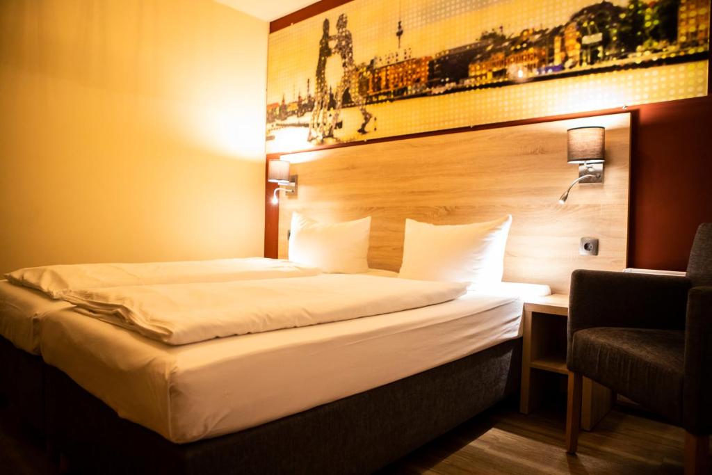 Postel nebo postele na pokoji v ubytování BlnCty Hotel