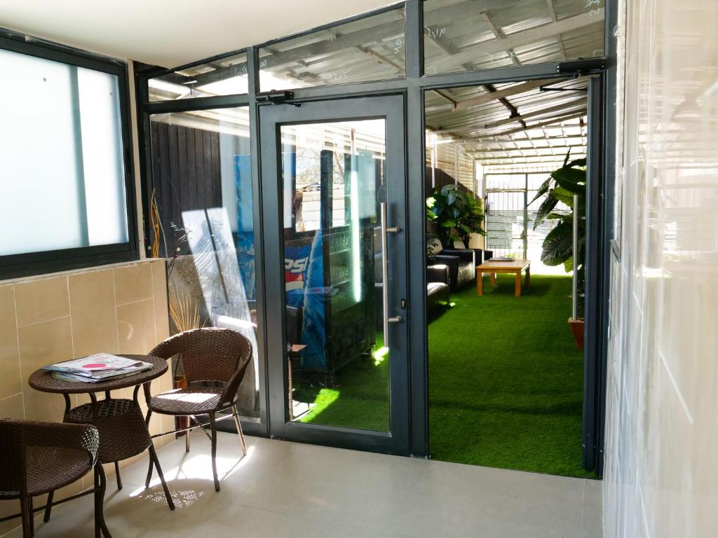 a room with glass doors and a table and chairs at InnTLV in Tel Aviv