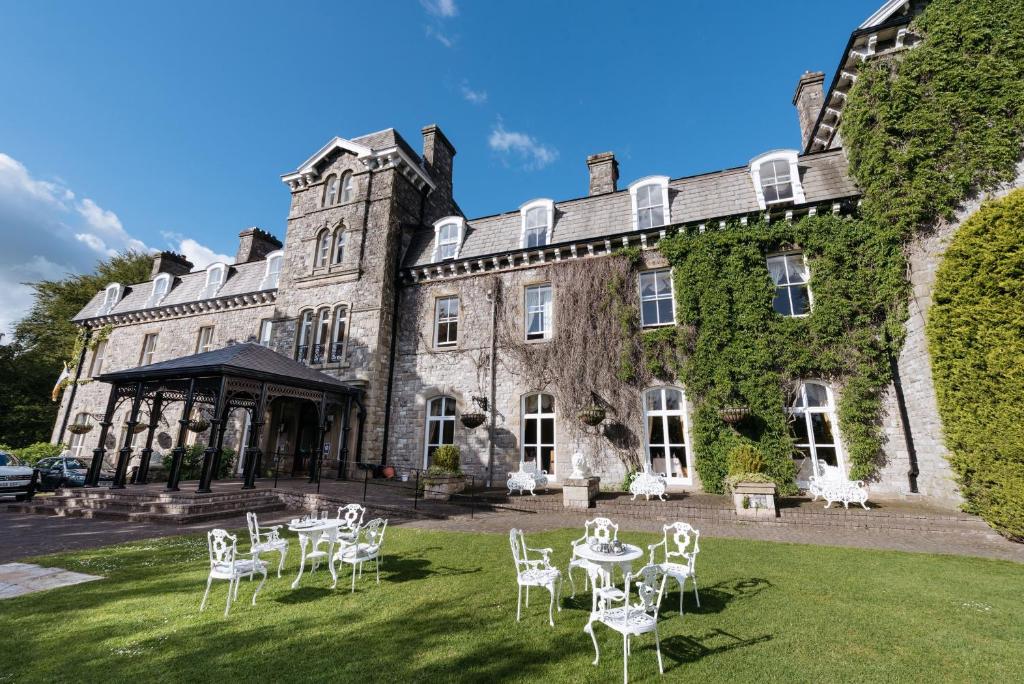 a large white house with a large clock on the front of it at Grange Hotel in Grange Over Sands
