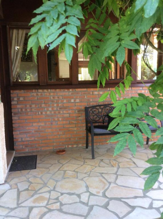 a bench sitting in front of a brick wall at Chez Uli in Angresse