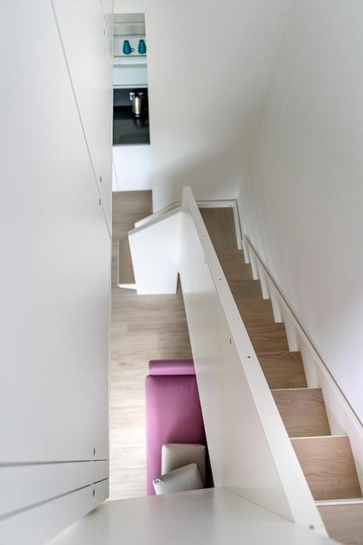 a staircase in a house with a pink stool at YOUMAMI Suite Hotel Wellness&Spa in Giulianova