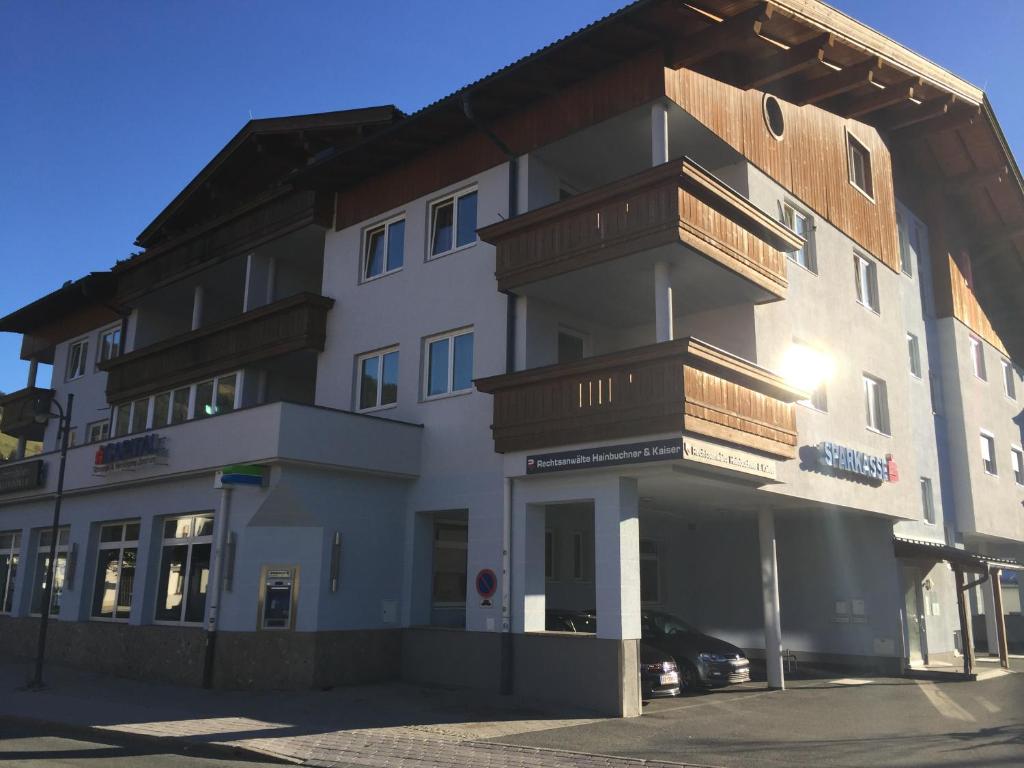 a large white building with wooden balconies on it at Penthouse Appartement in Kirchberg in Tirol