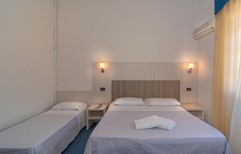 Postel nebo postele na pokoji v ubytování Hotel Perla Del Mare