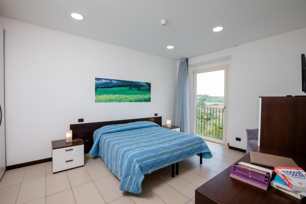Posteľ alebo postele v izbe v ubytovaní Porta Pispini Residence