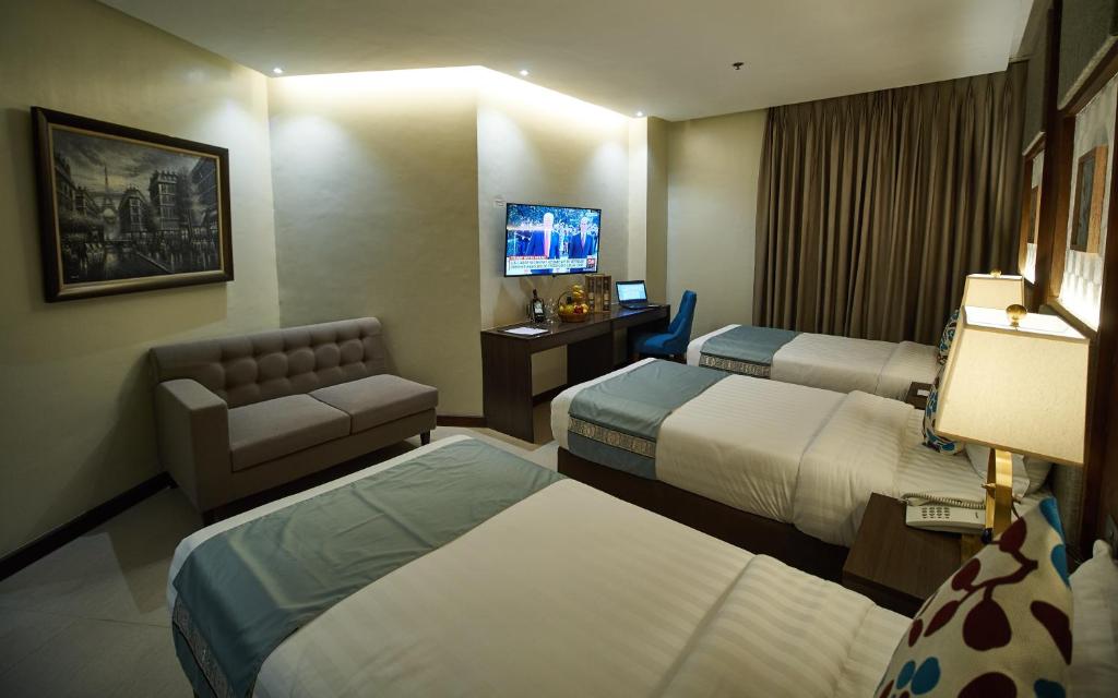 Postel nebo postele na pokoji v ubytování J7 Plaza Hotel