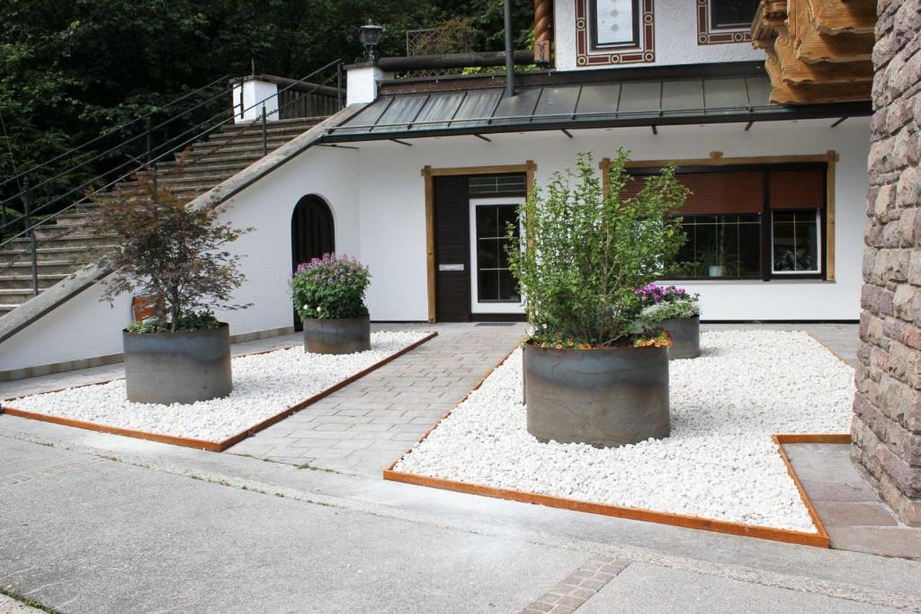 three potted plants in front of a building at Fewo Ziemer in Piding