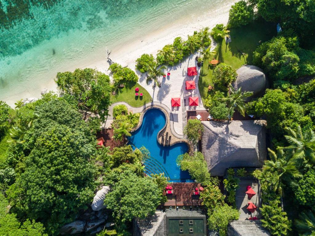 an aerial view of a resort next to the beach at Anantara Maia Seychelles Villas in Anse Boileau