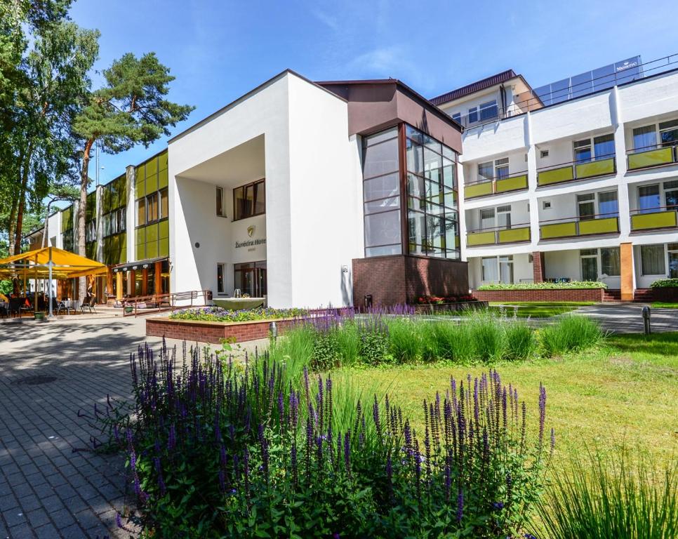 an office building with a garden in front of it at Žuvėdra in Palanga