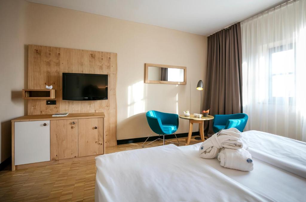 Postel nebo postele na pokoji v ubytování Rogner Bad Blumau