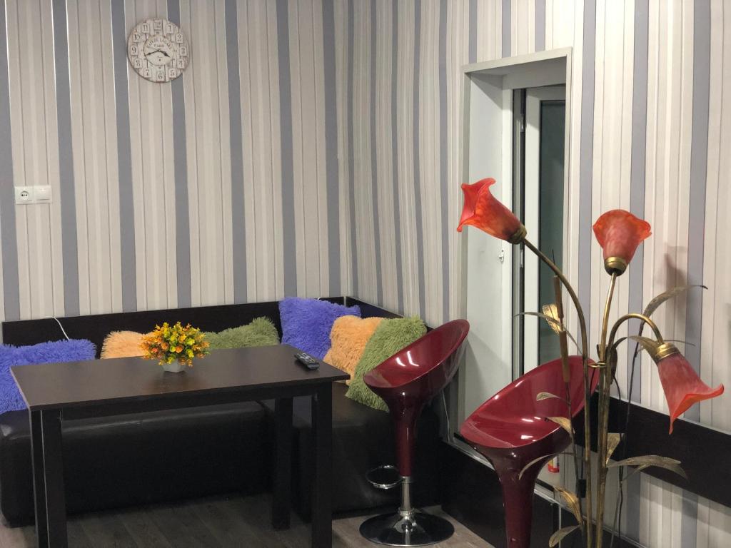 a living room with a black couch and a table at Metax House Yerevan in Yerevan