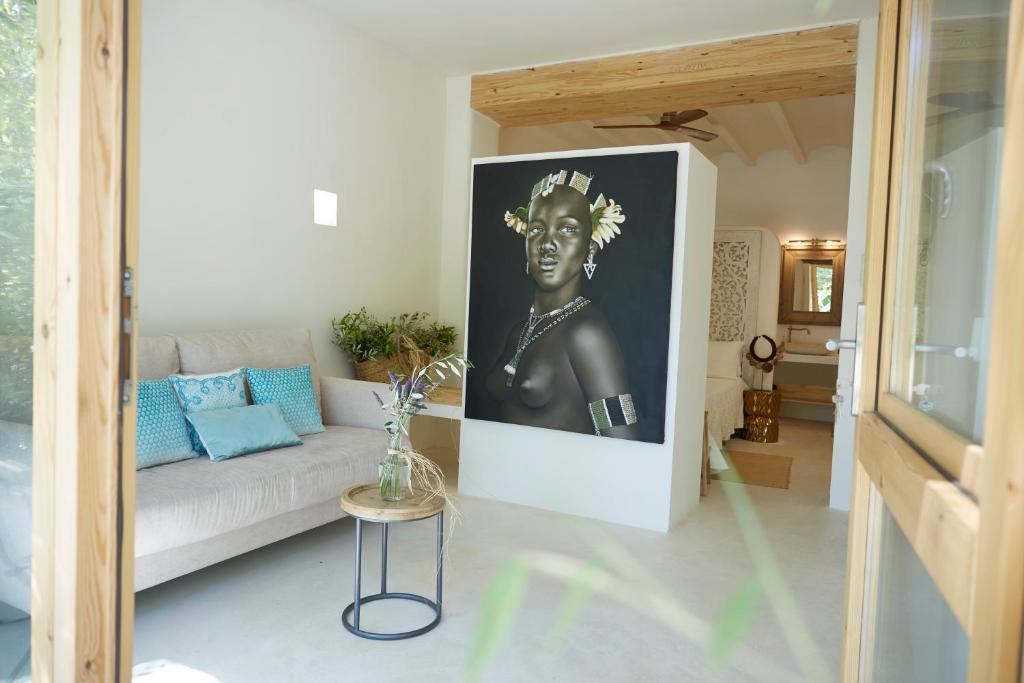 a living room with a couch and a picture of a man at Boho Suites Denia in Denia