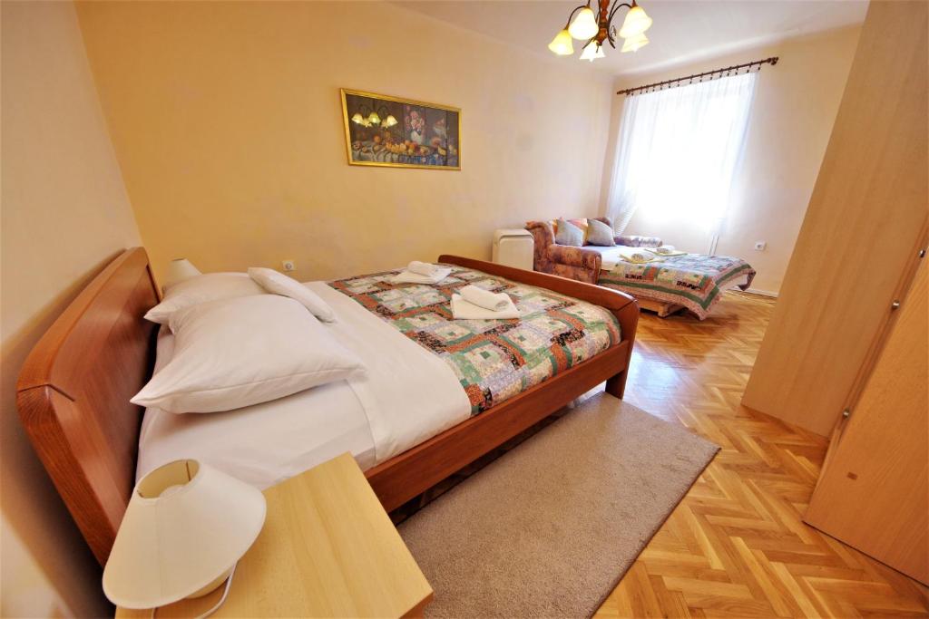 Posteľ alebo postele v izbe v ubytovaní Apartman Olive Garden