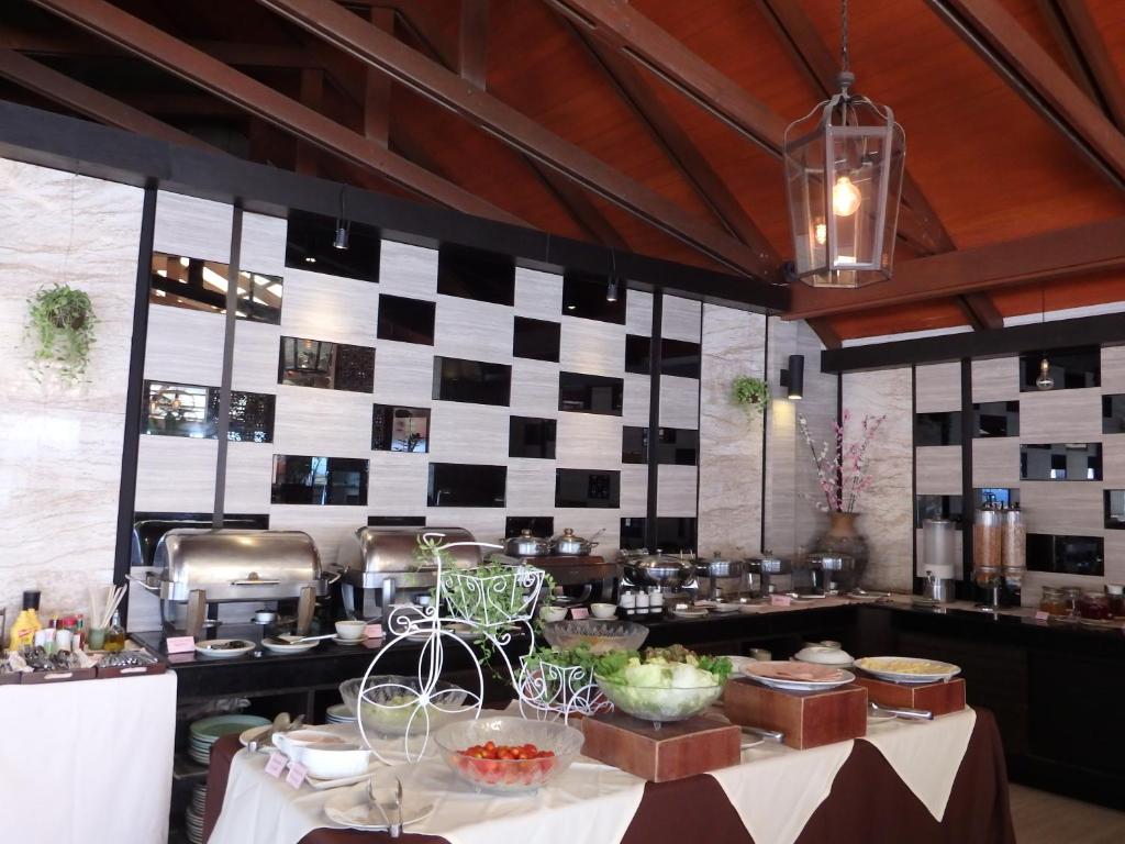 a kitchen with black and white checkered wall at Montien House - SHA Plus in Chaweng