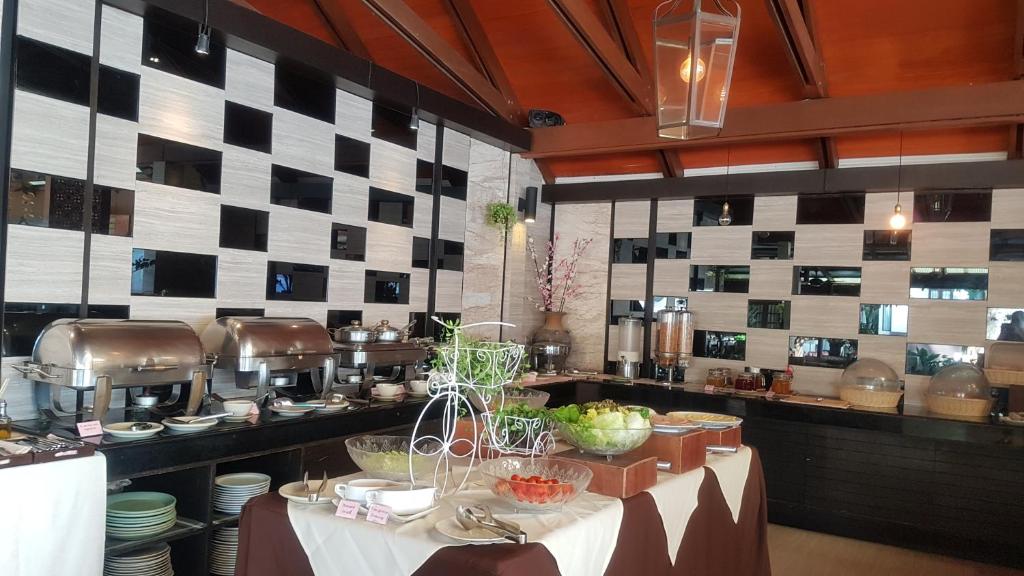 a kitchen with a table with food on it at Montien House - SHA Plus in Chaweng