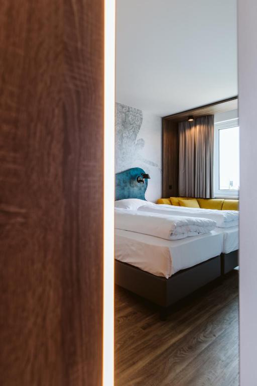 Postel nebo postele na pokoji v ubytování Hotel Rainers21