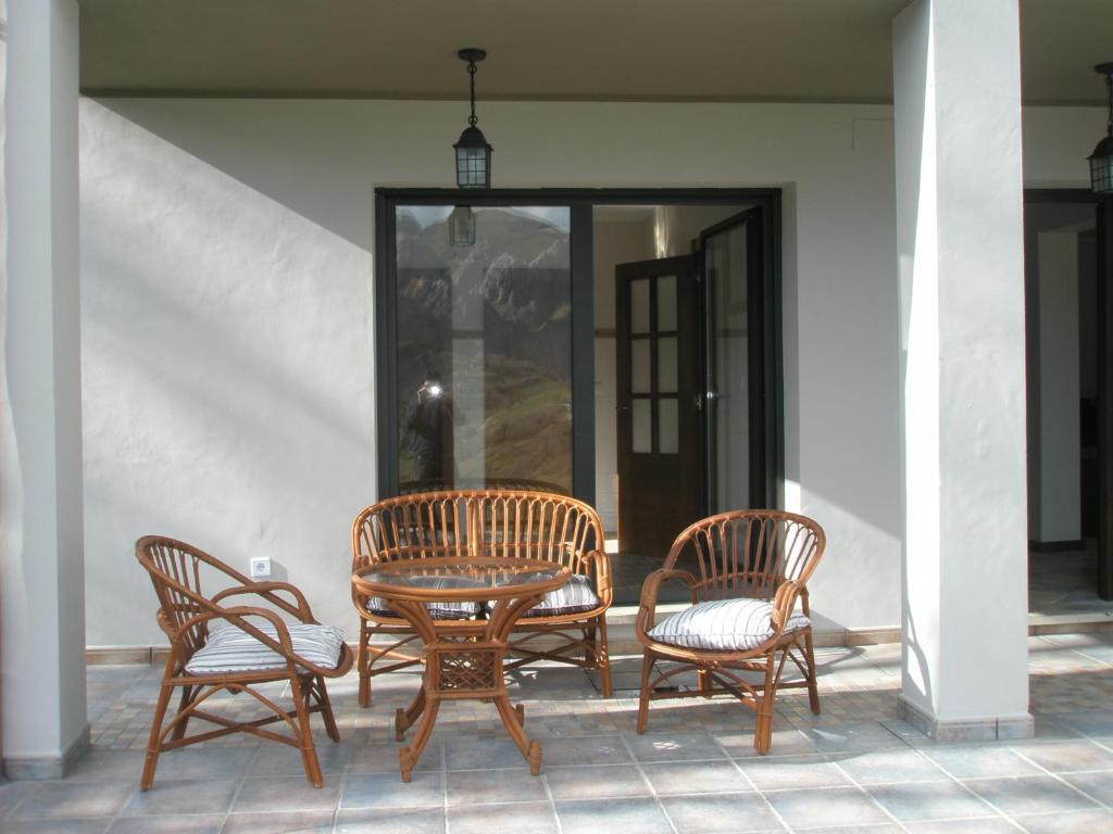un grupo de cuatro sillas y una mesa en un patio en La Senda del Casaño, en Canales