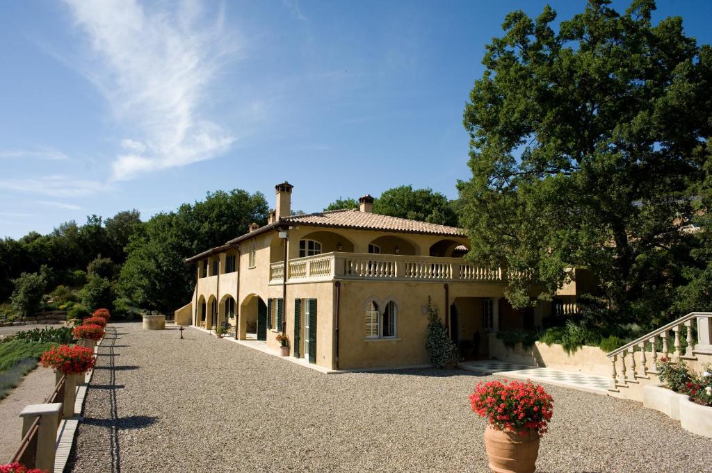 a large house with a balcony on top of it at Tenuta il Sassone - Wine&Food in Massa Marittima