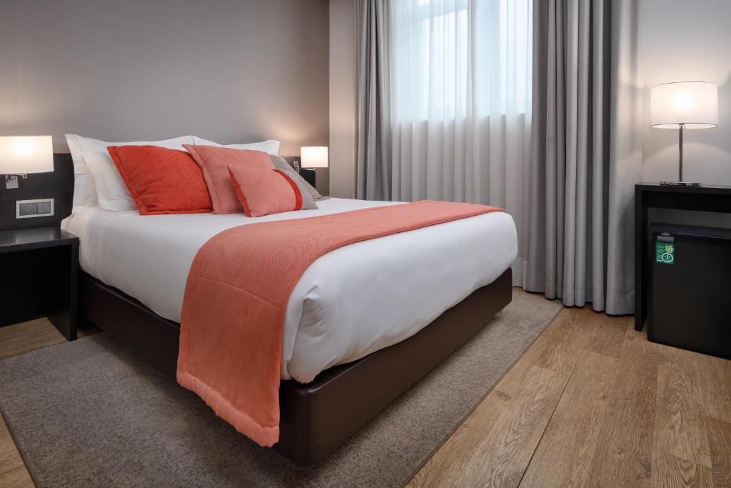 Postel nebo postele na pokoji v ubytování TURIM Aveiro Palace Hotel