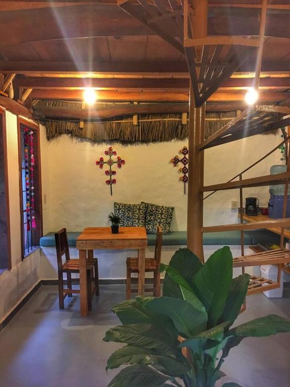 a dining room with a table and chairs in a room at Palapa Chili # in Sayulita