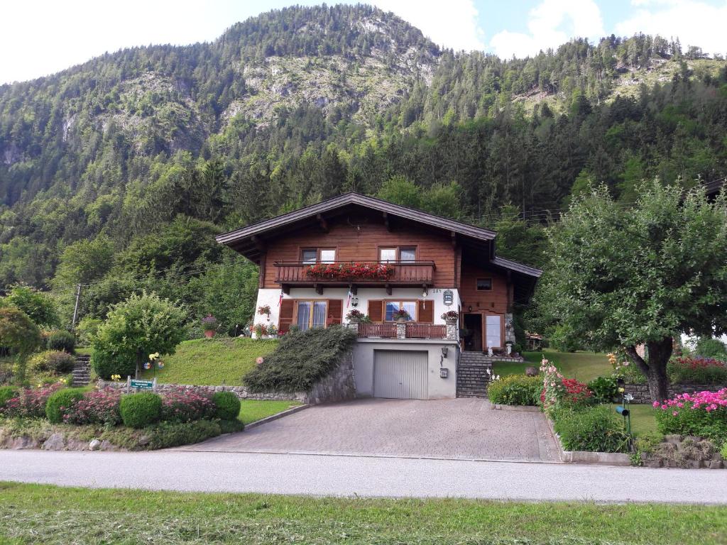 a house with a garage in front of a mountain at Haus Hauser in Lofer