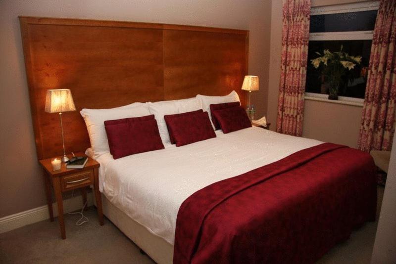 מיטה או מיטות בחדר ב-Lake Lodge Guesthouse