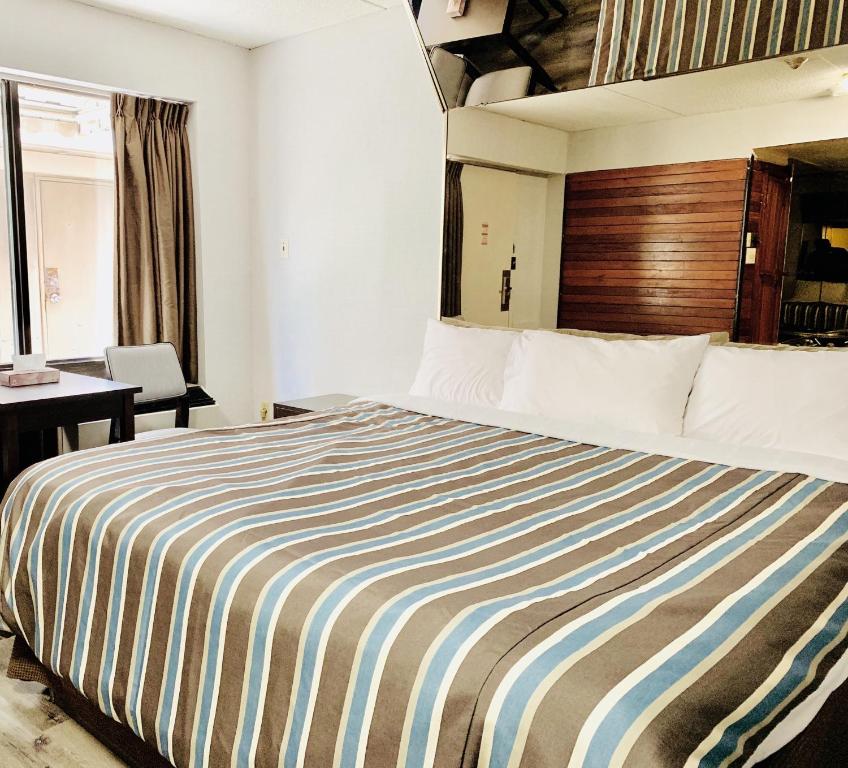 Postel nebo postele na pokoji v ubytování Deluxe Inn