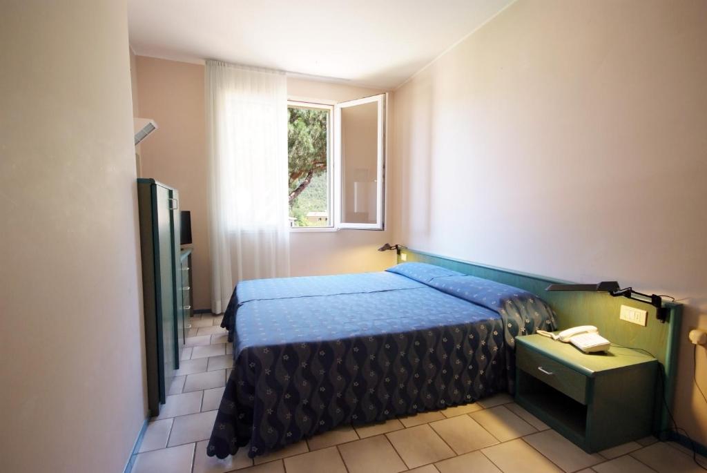 Postel nebo postele na pokoji v ubytování Hotel Residence Isola Verde