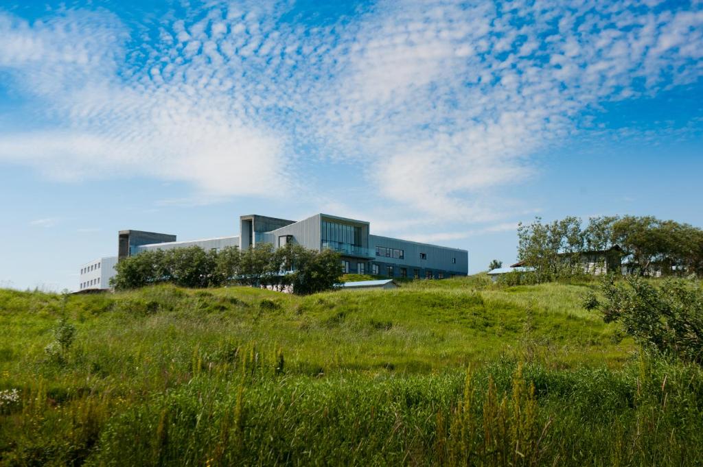 a building on top of a grassy hill at Hotel Laki in Kirkjubæjarklaustur