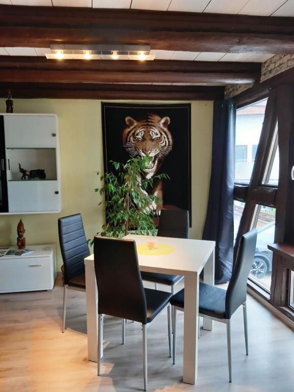a table with a picture of a tiger on the wall at Ferienhaus Bine in Kleinvach