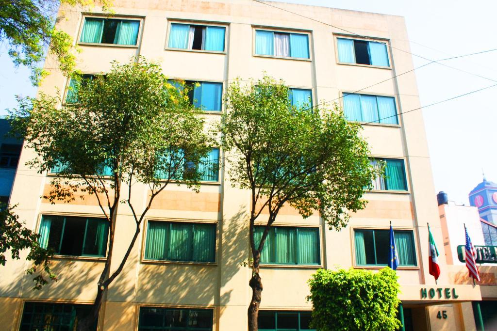 a tall building with trees in front of it at Hotel New York Ciudad de Mexico in Mexico City
