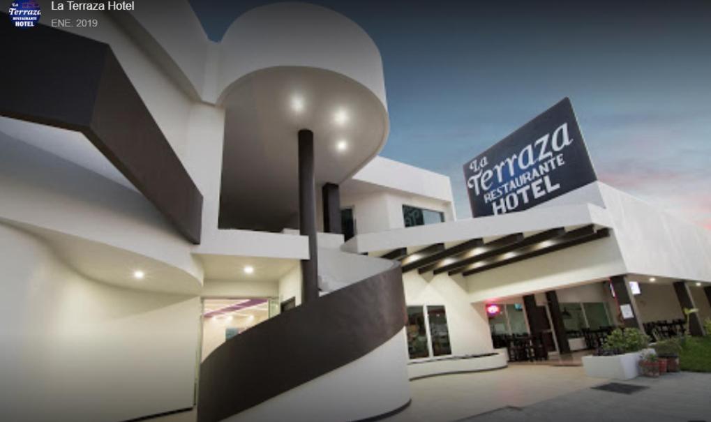 a building with a sign on the side of it at La Terraza Hotel in Jalpan de Serra