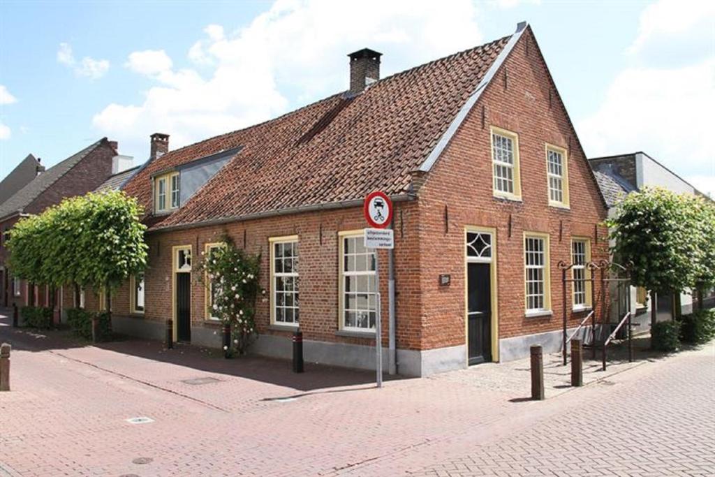 a brick building with a no parking sign in front of it at De Hoefstal 1765 in Asten