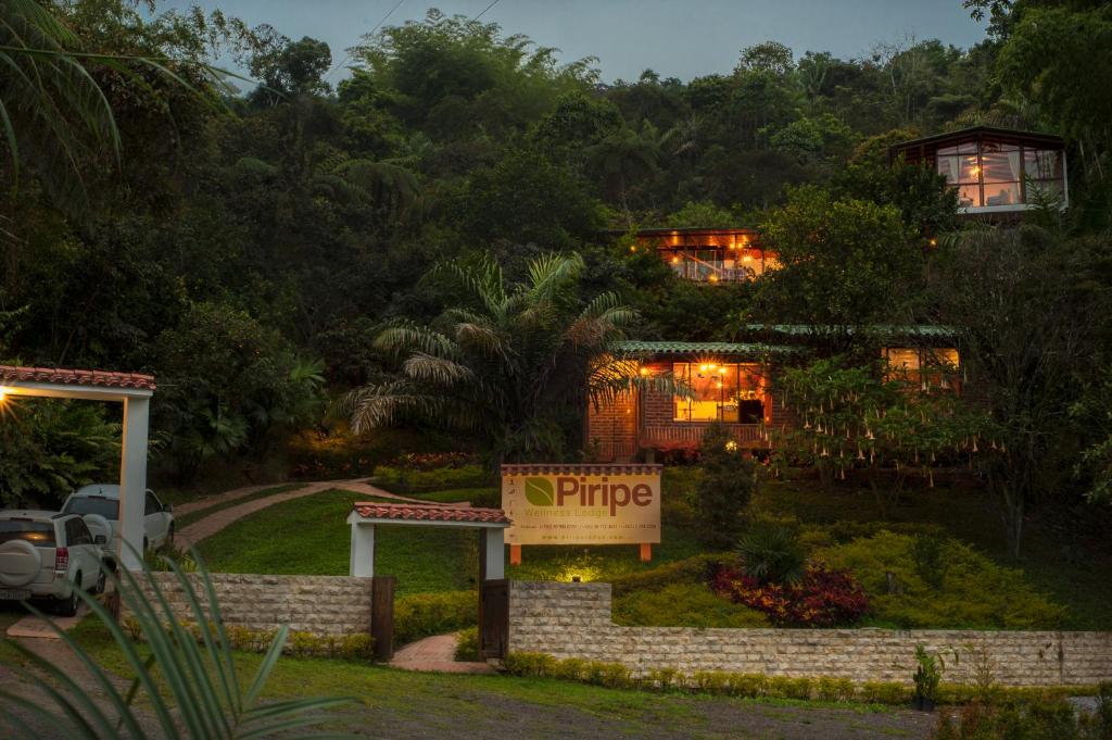 a hotel with a pineapple sign in front of it at Piripe Wellness Lodge in Pacto
