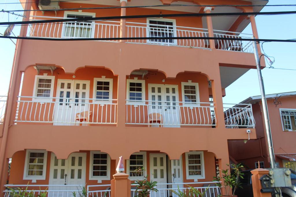 an orange building with white windows and balconies at Wallace Holiday Apartments in Scarborough