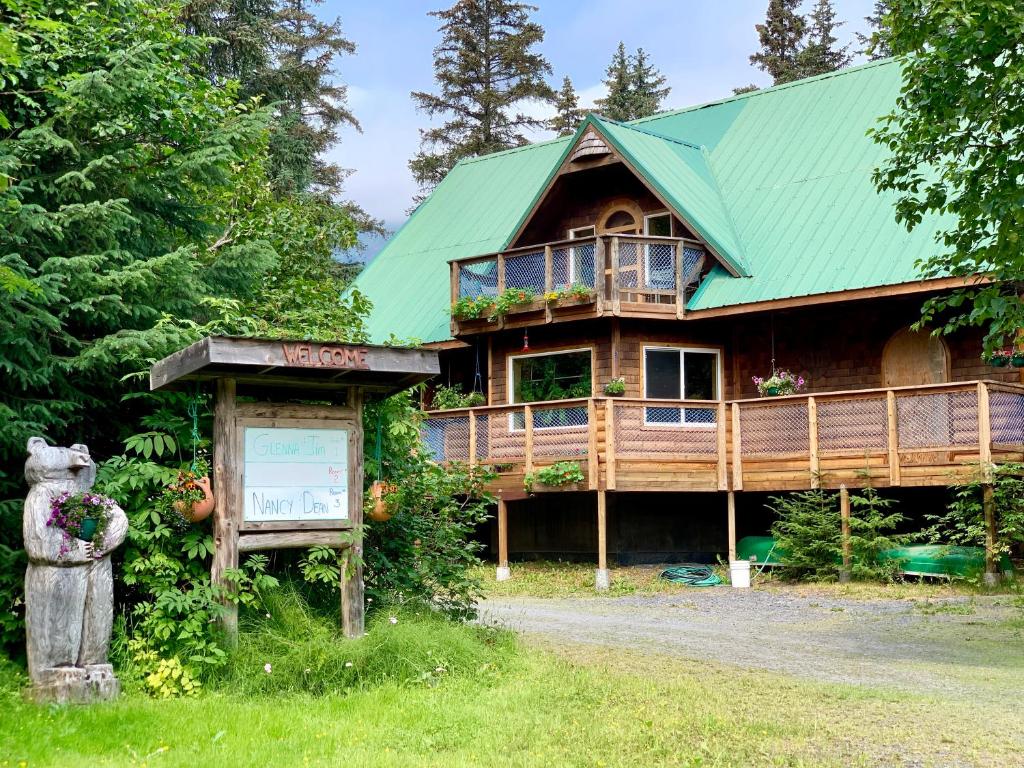 a large wooden house with a green roof at Sourdough Sunrise B&B in Seward