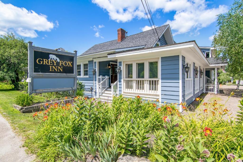 a house with a sign for a grey fox inn at Grey Fox Inn in Stowe