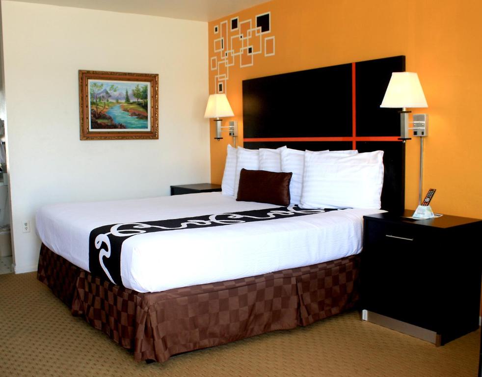 a hotel room with a large bed in it at Chaparral Motor Inn in Burlington