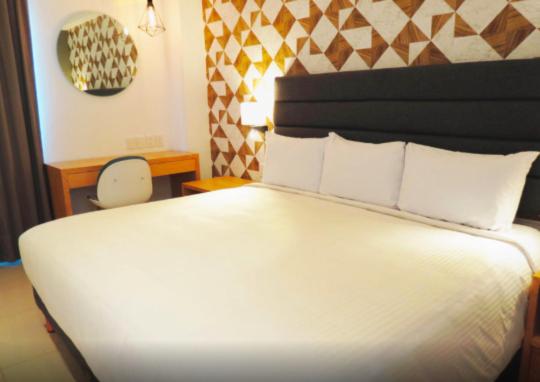 Postel nebo postele na pokoji v ubytování Hotel Urbainn
