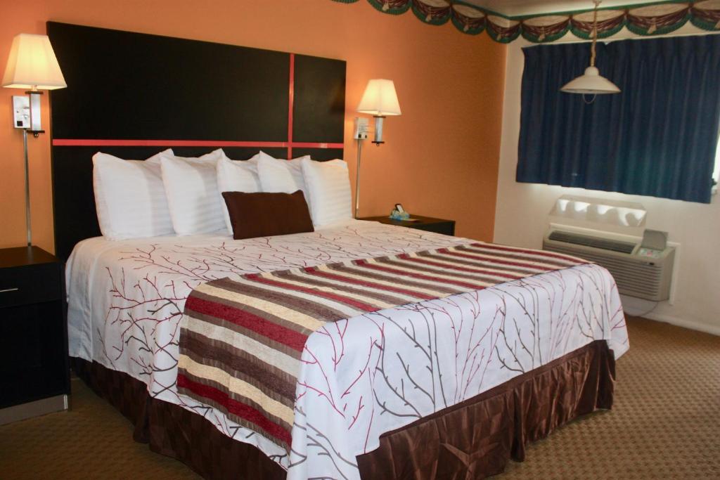 a hotel room with a large bed in a room at Chaparral Motor Inn in Burlington