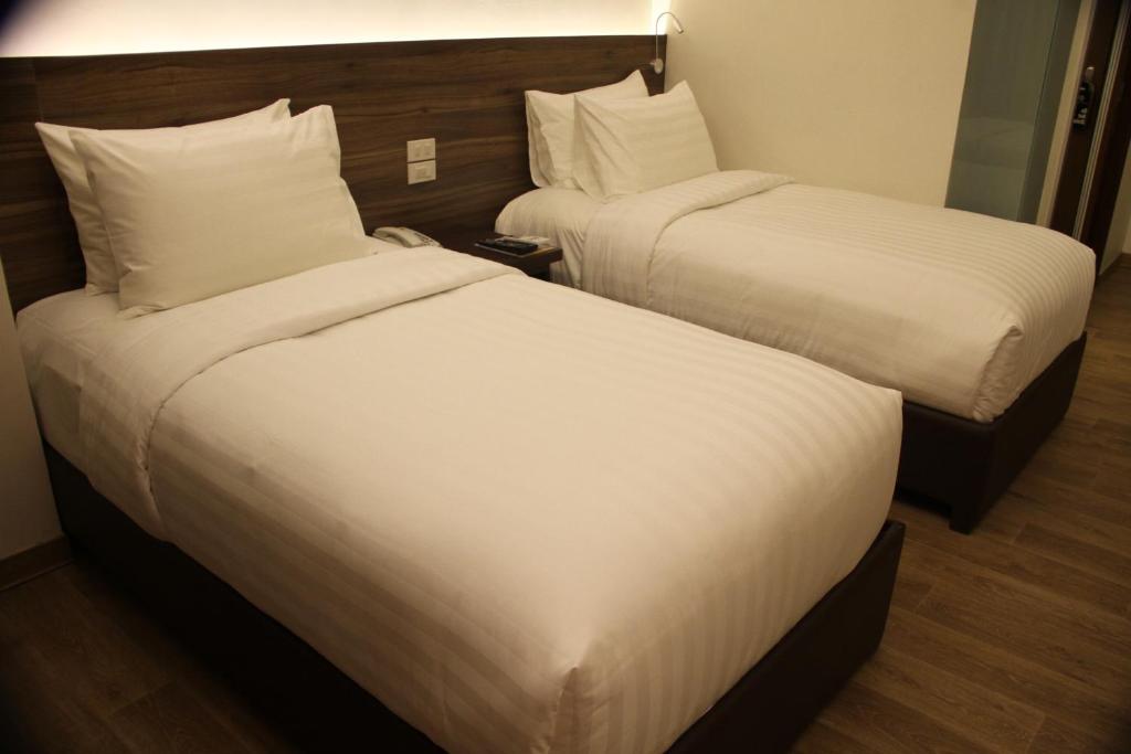 Postel nebo postele na pokoji v ubytování Hotel Marciano